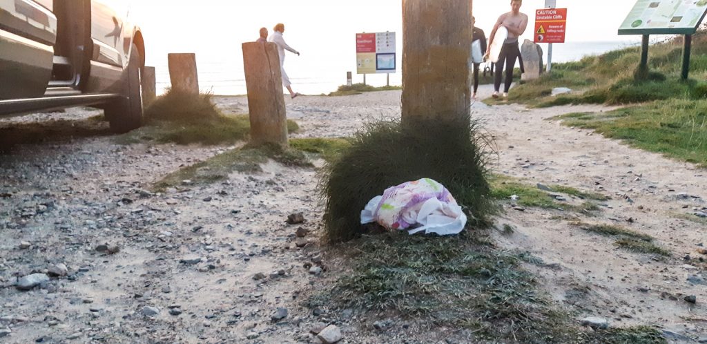 Create less rubbish on holiday - A discarded nappy in the sunset