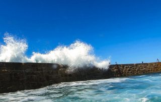 Sennen Harbour wall and wave